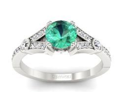 Złoty pierścionek ze szmaragdem i brylantami - P15304bsm