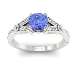 Złoty pierścionek z tanzanitem z brylantami - P15304bt