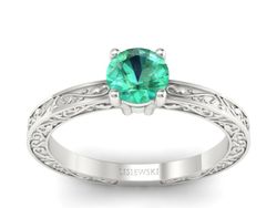 Złoty pierścionek ze szmaragdem w białym złocie 585 - p16278bsm